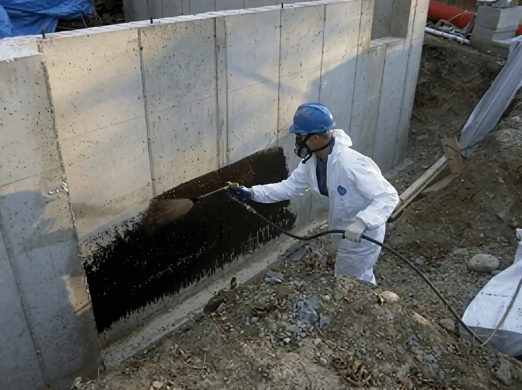 Professional waterproofing the exterior walls of the basement in Albuquerque, NM