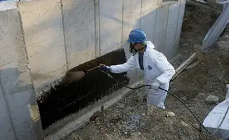 Professional waterproofing the exterior walls of the basement in Albuquerque, NM