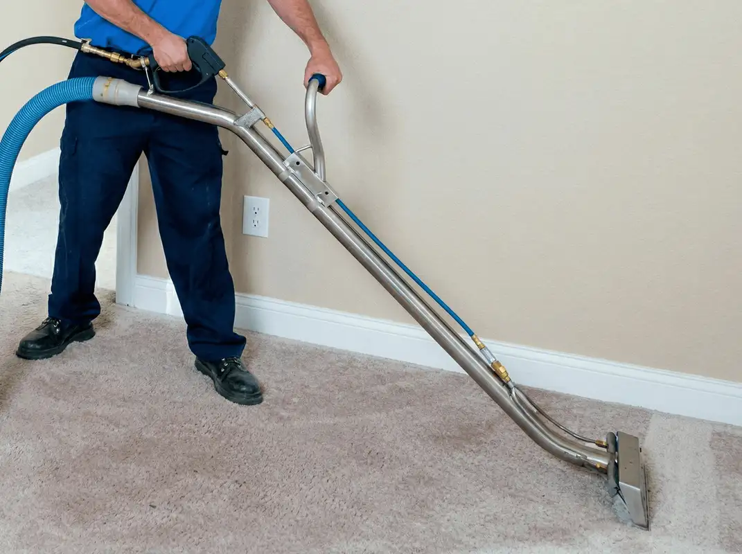 Professional operating a liquid removal machine on a carpeted floor in Albuquerque, NM